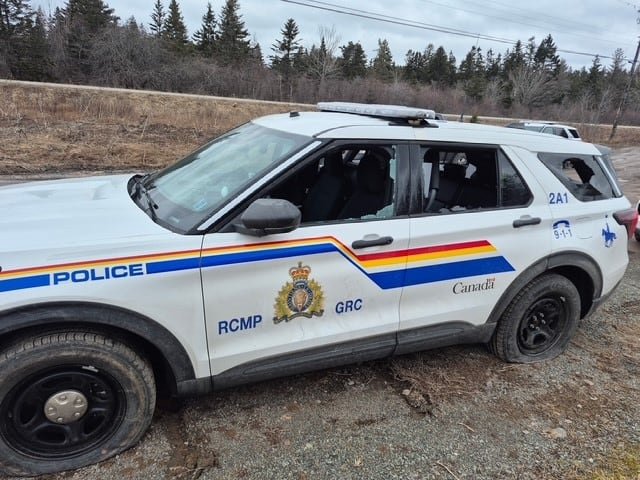 RCMP officers abandon their vehicles as they flee Potlotek First Nation after carrying out a raid at a cannabis store.